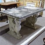 A weathered stoneware rectangular garden table on mythological beast supports, 4'2" x 2'10"