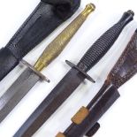 2 Fairbairn-Sykes fighting knives with leather scabbards, and a reference book