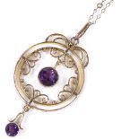 An Edwardian 9ct rose gold amethyst pendant necklace, with openwork stylised settings, on 9ct chain,