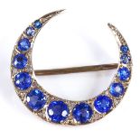 A Victorian unmarked gold graduated blue stone and diamond crescent brooch, diameter 23.8mm, 2.4g