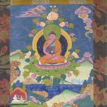 A Chinese hand painted thangka depicting a seated Buddha, in floral textile border, 68cm x 50cm