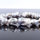 A single-strand Princess Baroque pearl necklace, with sterling silver clasp, necklace length 16",