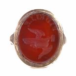 An unmarked gold carnelian intaglio seal signet ring, with motto "Fidelle", and dove emblem, setting