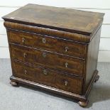 An 18th century walnut chest of 3 long drawers, with feather-banded and quarter veneered top,