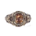 A Georgian unmarked gold foil-back citrine panel ring, with pierced and relief engraved rose