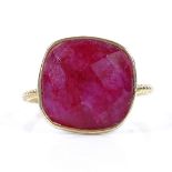 An unmarked silver-gilt faceted ruby panel ring, with milled shank, setting height 15.2mm, size P,