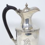 An Edwardian silver hot water jug, with banded body and acanthus leaf decoration, by Horace Woodward