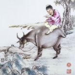 A Chinese porcelain plaque with hand painted scene depicting a figure riding a water buffalo,