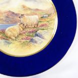 A plate with hand painted scene depicting sheep in a landscape, signed Francis Clark, diameter 27cm