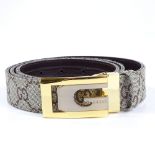 A Gucci leather belt, new and boxed condition