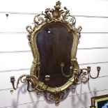 An ornate 19th century gilt-gesso framed shield-shaped wall mirror, with 6 candle brackets,