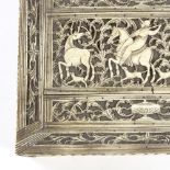 An 18th/19th century ivory box, the relief carved and pierced lid depicting a stag hunting scene,