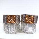 A pair of Art Deco style wall light fittings, with inset relief-embossed copper panels and