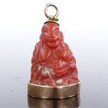 An 18ct gold mounted carved coral Buddha pendant, pendant height 26.7mm, 7.3g