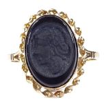 A 9ct gold relief moulded onyx seal ring, with twist surround, setting height 17.2mm, size Q, 1.8g