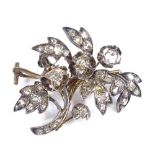 An unmarked gold diamond set floral spray brooch, brooch length 33.6mm, 6.3g
