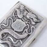 A Chinese silver cigarette case, with relief embossed dragon and flower decoration, stamped on