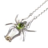 A silver gold and cabochon peridot figural spider pendant necklace, on silver belcher link chain,