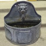 A heavy semi-circular lead fountain with lion spout, width 2'7" , height 2'7"