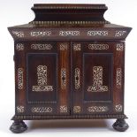 A 19th century rosewood sewing cabinet, with inlaid mother-of-pearl marquetry and carved