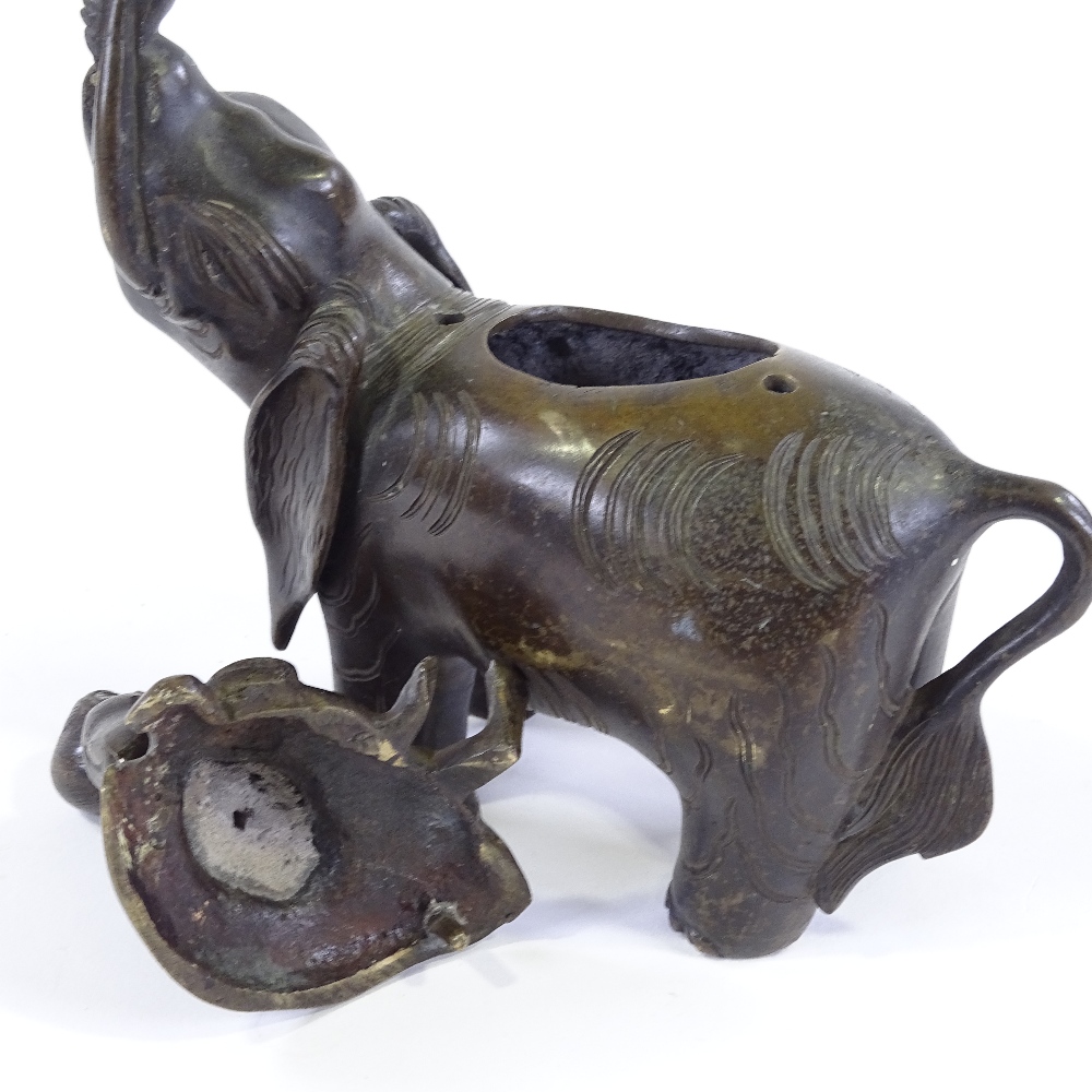 A Chinese patinated bronze incense burner, in the form of a figure seated on an elephant, height - Image 3 of 3