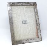 A George V silver-fronted photo frame, by Harrods Stores Ltd, hallmarks London 1914, model no.