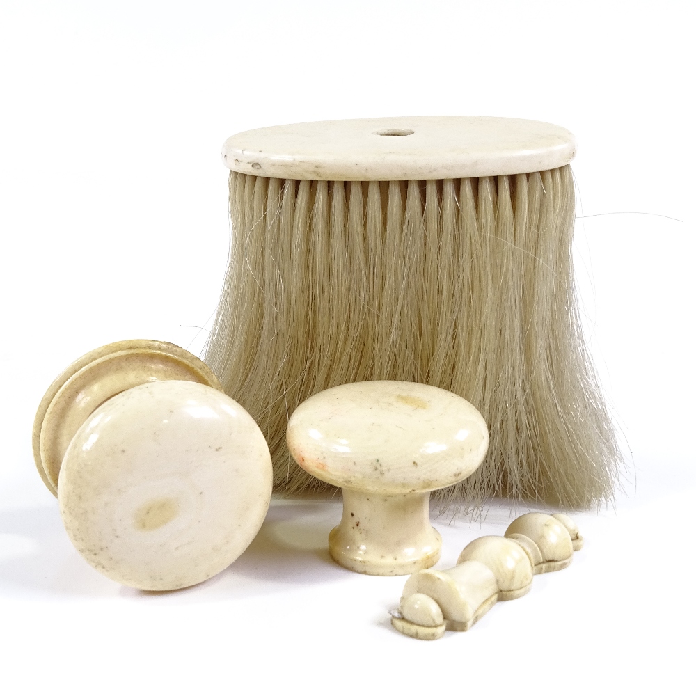 A pair of Victorian ivory doorknobs and matching lock escutcheon, and an ivory handled brush