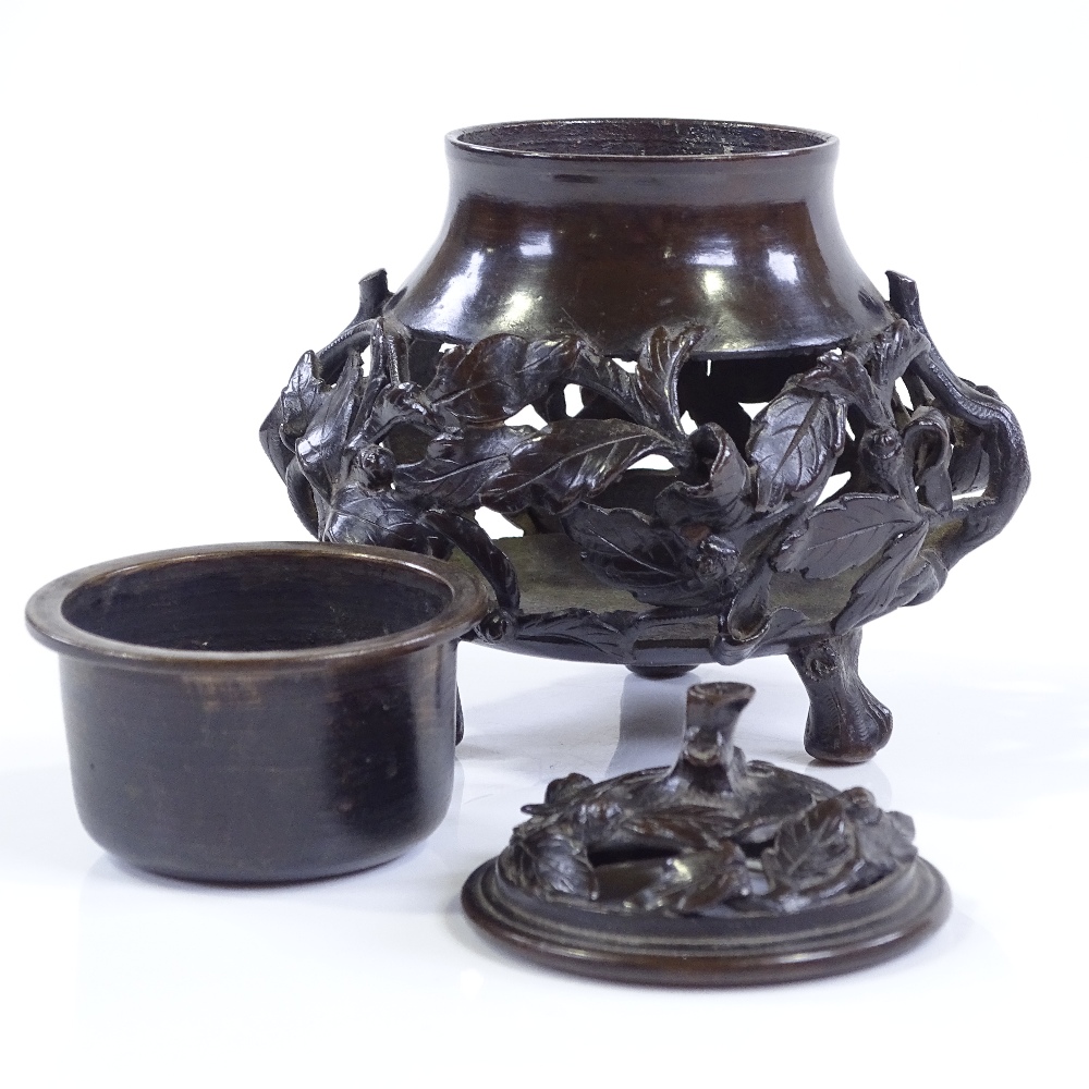 A Chinese patinated bronze incense burner, with relief cast leaf moulded surround, and original - Image 2 of 3