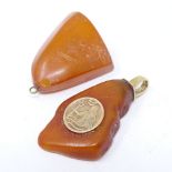 An 8ct gold mounted butterscotch amber pendant, with Poseidon panel, height 51.6mm, and another