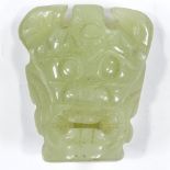 A Chinese carved jade mask buckle, height 5.5cm