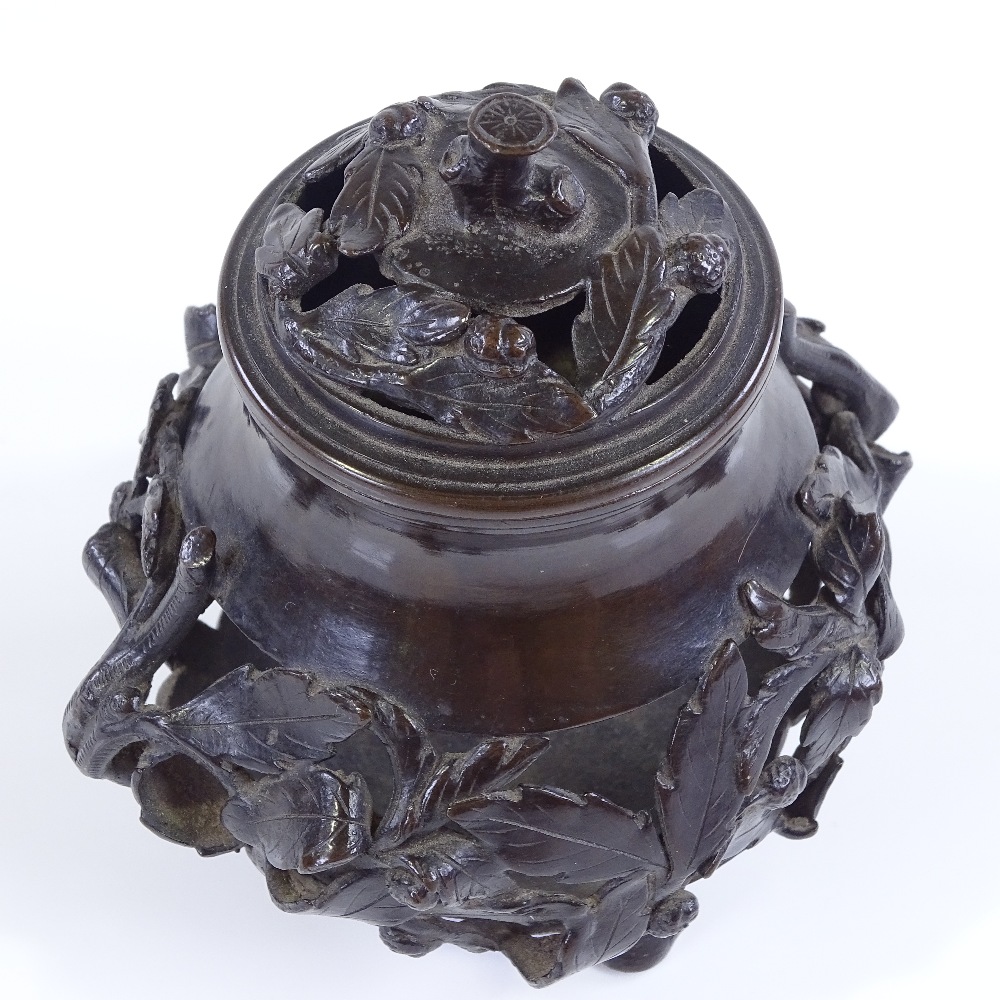 A Chinese patinated bronze incense burner, with relief cast leaf moulded surround, and original - Image 3 of 3