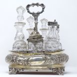A Victorian silver and glass table cruet set, with relief embossed floral decoration, indistinct