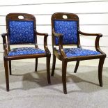 A pair of Regency carved mahogany elbow chairs