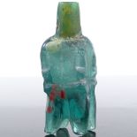 A Fatimid green glass molar design flask, length 6.5cm