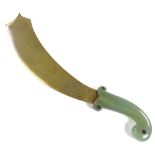 An Indo-Persian curved ceremonial dagger, with engraved gilt-metal blade and carved green jade