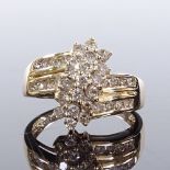 A 14ct gold diamond cluster flowerhead ring, with channel set diamond shoulders, total diamond