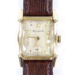 BULOVA - an Art Deco gold plated mechanical wristwatch, champagne dial with Deco Arabic numerals,