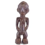 A Baule carved and stained wood Ancestor figure, height 34cm