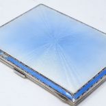 A rectangular silver and blue enamel cigarette case, with engine turned decoration and gilt