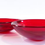 A pair of Whitefriars ruby red 3-sided bowls, designed by Geoffrey Baxter 1960-'63, 24.5cm across