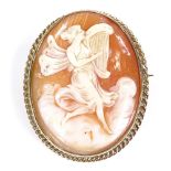 A relief carved cameo shell brooch, depicting lady with harp, in unmarked gold rope twist frame,