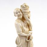 A Japanese Meiji Period ivory carving of a fisherman with baskets and net, height 27cm
