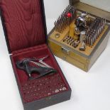 HOROLOGY INTEREST - A Seitz jewelling tool with pushers and reamers, together with a cased staking