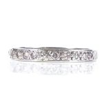 An unmarked white metal diamond eternity ring, total diamond content approx 0.5ct, band width 2.9mm,