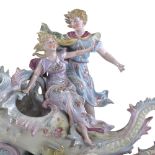 A porcelain table centre bowl in the form of 2 children riding a seashell, length 36cm
