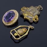 An unmarked yellow metal stone set owl pendant, an unmarked gold amethyst pendant, and a gilt-