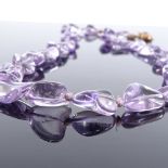 A single strand of polished amethyst beads, on 9ct floral clasp, necklace length 62cm, 102.2g (