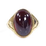 A Victorian 18ct gold foil-back cabochon garnet signet ring, with engraved shoulders and bridge,