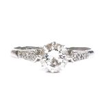 An 18ct white gold 0.95ct solitaire diamond ring, with diamond set platinum-topped shoulders,