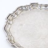 A circular silver salver, scalloped rim with scrolled acanthus feet, by Viner's Ltd, hallmarks